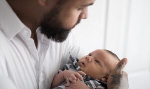 A father holding his newborn infant