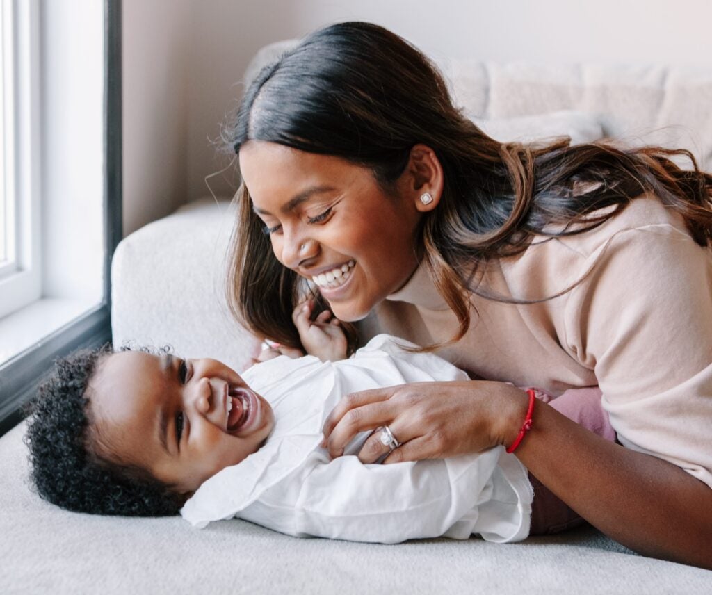 A smiling mother being playful with her son