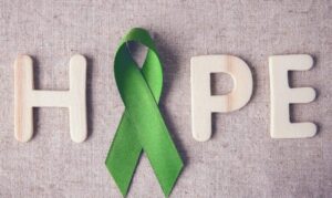 HOPE spelled out with wooden letter and the 'O' as a green ribbon.