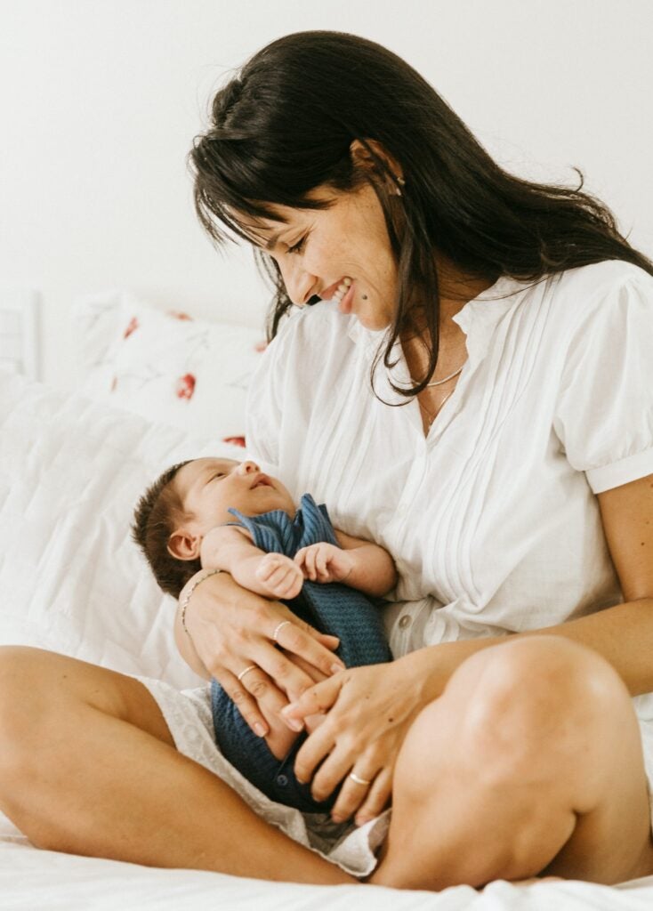 A mother sitting with her infant