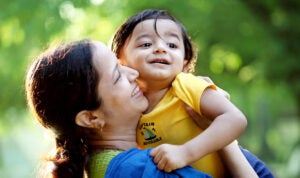 A mother kissing young child on the cheek