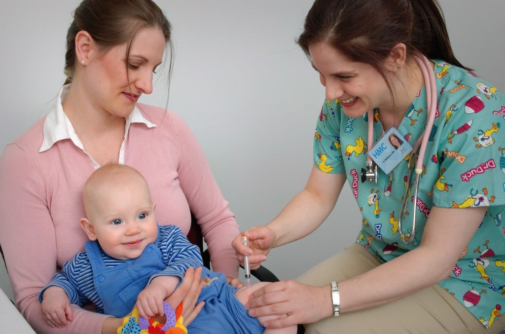 Young Mom Holding Baby Getting a Shot