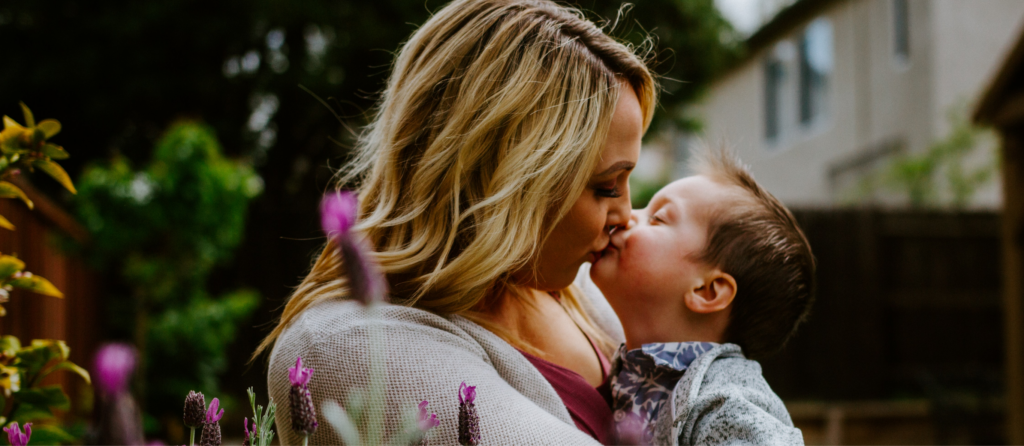 A mother holding her child and showing affection