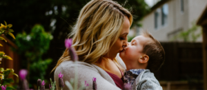 A mother holding her child and showing affection